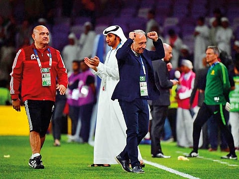 UAE coach Alberto Zaccheroni (in blue suit) celebrates his team’s 1-0 win over Australia in Al Ain on Friday.
