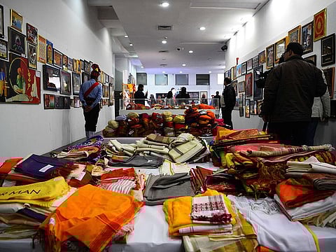 Indian visitors looks towards the gifts received by Indian Prime Minister Narendra Modi at an auction, in New Delhi on January 27, 2019. 