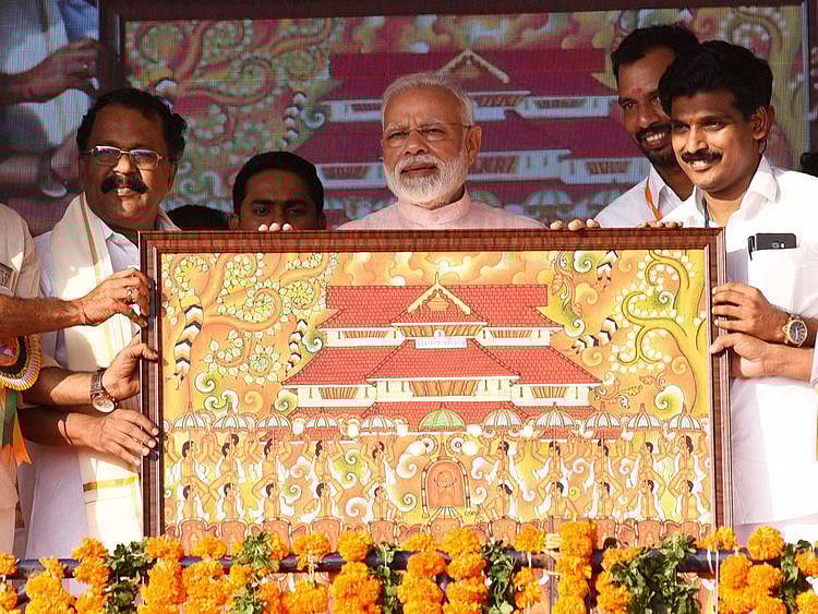 India's Prime Minister Narendra Modi being presented a memento
