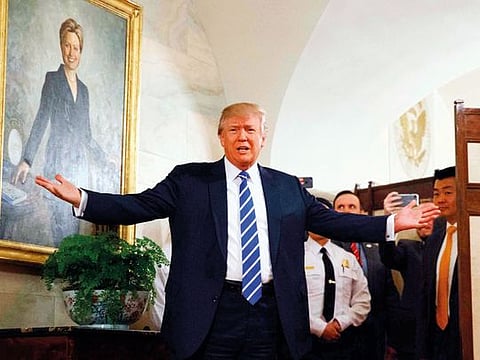 President Donald Trump greets visitors touring the White House on March 7, 2017.