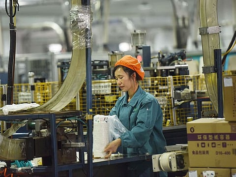 An employee packages paper bowls at a factory in Hangzhou in China's eastern Zhejiang province. China’s factory activity slipped into contraction in August for the first time in nearly 1-1/2 years as COVID-19 containment measures. 