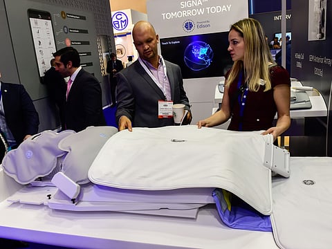 Visitors looking at light and comfortable MRI blanket - Air Technology by GE Healthcare at the Arab Health 2019 at Dubai World Trade Centre on Tuesday 29 January 2019. 