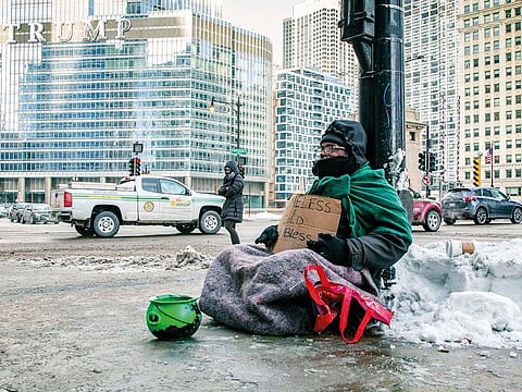 A homeless man panhandles on Upper Wacker Drive in Chicago.