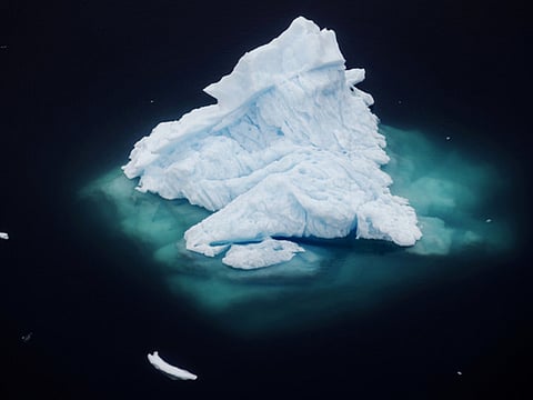 An iceberg floats in a fjord near the town of Tasiilaq, Greenland