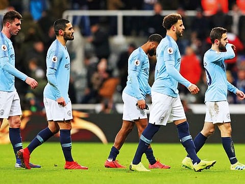 Manchester City players after losing 1-2 to Newcastle. The loss gave Liverpool the edge in the title rice.