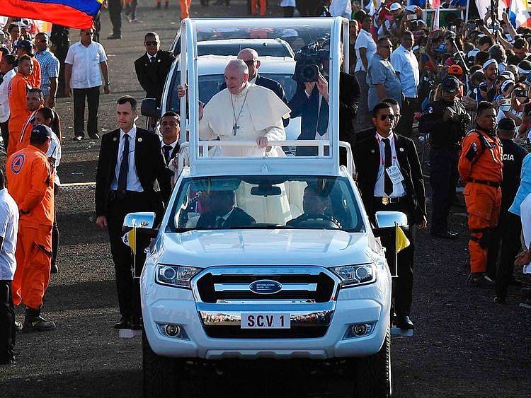 Pope Francis waves to pilgrims
