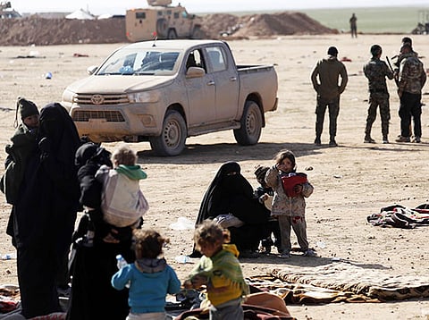 Civilians fleeing from fighting between Syrian Democratic Forces (SDF) and Daesh jihadists in the frontline Syrian village of Baghuz, await to be screened and registered by the SDF in the countryside of the eastern Syrian Deir Ezzor province on January 31, 2019.  