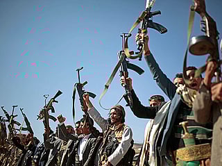 Tribesmen loyal to Al Houthi rebels hold up their weapons as they attend a gathering to show their support for the ongoing peace talks in Sanaa, Yemen. File photo taken on December 13, 2018.