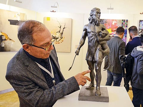 A man looks at a displayed sculpture in the museum of Mosul, Iraq The building was recently renovated to host the 29-artist exhibit, titled “Return to Mosul”.