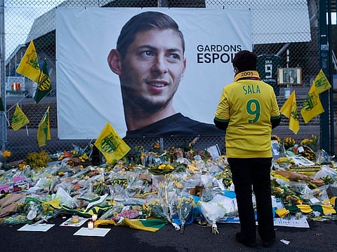 A Nantes supporters stops by a poster of Argentinian player Emiliano Sala and reading "Let's keep hope" outside La Beaujoire stadium before the French League One match Nantes against Saint-Etienne, in Nantes, western France.