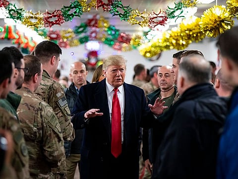 President Donald Trump visits members of the U.S. military at a dining hall at Al Asad Air Base in Iraq