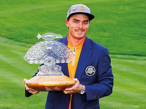 Rickie Fowler holds the champion's trophy after the final round of the Phoenix Open PGA golf tournament, on Sunday, in Scottsdale, Arizona. 