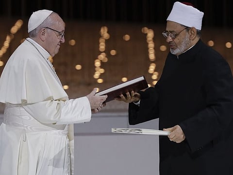 Abu Dhabi:  Pope Francis, left, and Sheikh Ahmed el-Tayeb, the grand imam of Egypt's Al-Azhar, exchange a joint statement on "human fraternity" after an interfaith meeting at the Founder's Memorial in Abu Dhabi, United Arab Emirates, Monday, Feb. 4, 2019. Pope Francis has asserted in the first-ever papal visit to the Arabian Peninsula that religious leaders have a duty to reject all war and commit themselves to dialogue. AP/PTI Photo(AP2_5_2019_000011B)