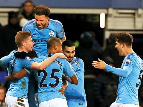 Manchester City's Gabriel Jesus, obscured, celebrates with teammates after scoring his side's second goal of the game against Everton during an English Premier League soccer match at Goodison Park, Liverpool, England, Wednesday. 