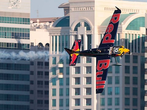 Kirby Chambliss of USA manoeuvres his plane during the qualifying round of the Red Bull Air Race World Championship in the Emirati capital Abu Dhabi