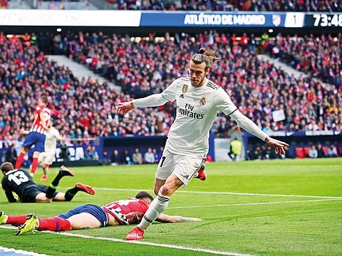 Real Madrid’s Gareth Bale celebrates after scoring his side’s third goal during a La Liga match against Atletico Madrid.