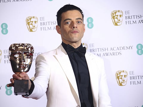 Actor Rami Malek poses backstage with his Best Actor award for his role in the film 'Bohemian Rhapsody' poses for photographers backstage at the BAFTA awards in London.