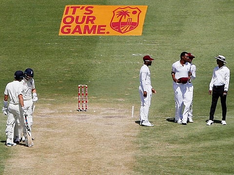 West Indies' Shannon Gabriel is lead away by Kraigg Brathwaite after an incident with England's Joe Root, at the Darren Sammy National Cricket Stadium in St Lucia on February 11, 2019. 