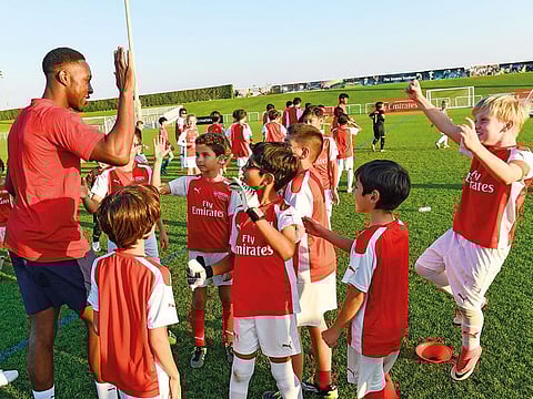Danny Welbeck of Arsenal with kids at the Arsenal soccer school at Seves in Dubai on Wednesday 13 February 2019.