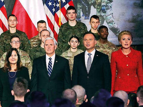 United States Vice President Mike Pence, 2nd from left, and his wife Karen Pence, left, stand together with Poland's President Andrzej Duda, 2nd from right and his wife Agata Kornhauser-Duda, right, in front of soldiers in Warsaw, Poland, Wednesday, Feb. 13, 2019.