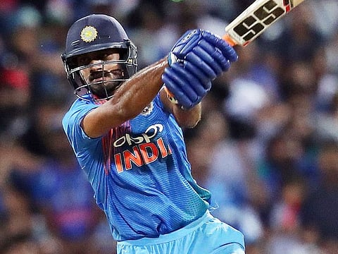 Vijay Shankar (R) plays a shot during the third Twenty20 international cricket against New Zealand in Hamilton on February 10, 2019. 