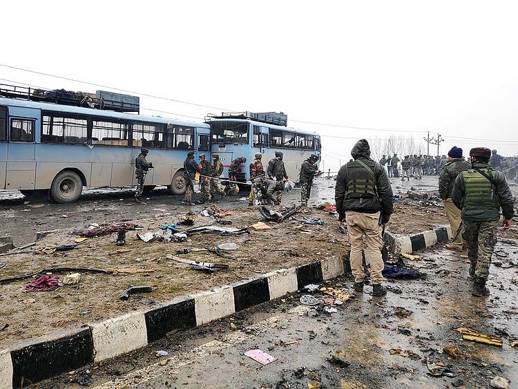 Indian soldiers examine the debris