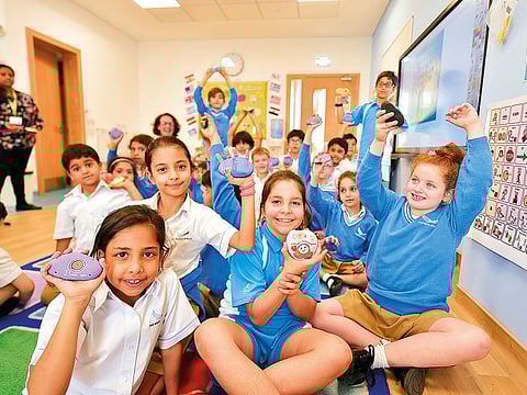 Kimia Mackay (right) holding ‘Gratitude Stones’ with her Aquila School friends. Students were given small rocks to register their sense of gratitude as part of the new campaign.