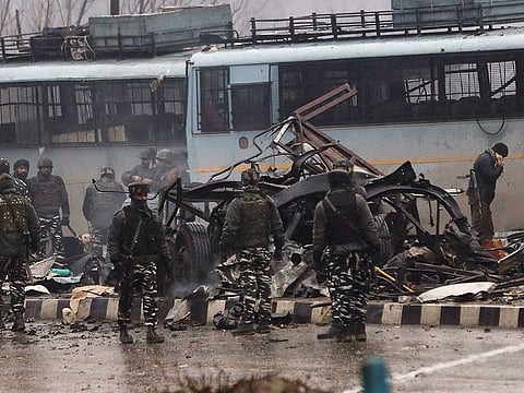 Indian security forces inspect the remains of a vehicle following an attack on a paramilitary Central Reserve Police Force (CRPF) convoy that killed at least 16 troopers and injured several others near Awantipur town in the Lethpora area of Kashmir about 30km south of Srinagar on February 14, 2019.