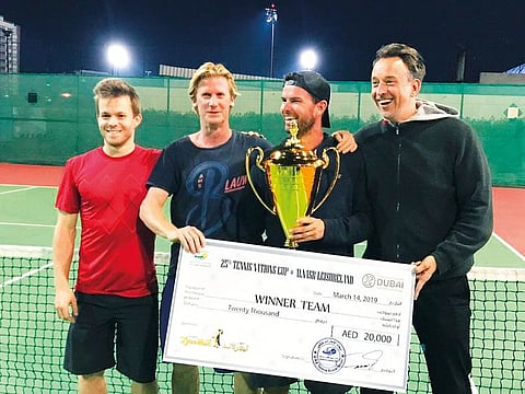 The Belgian tennis team with the winners cheque for Dhs 20,000 after clinching their third title at the Al Nasr Leisureland courts.