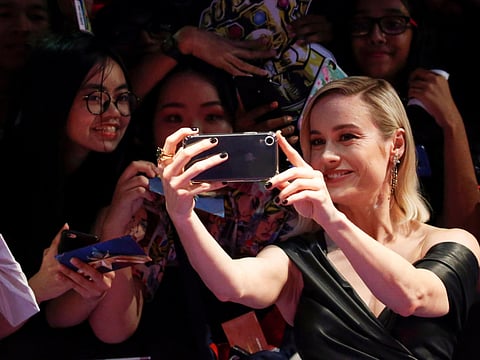 Captain Marvel cast member Brie Larson poses for a selfie with fans in Singapore, February 14, 2019. 