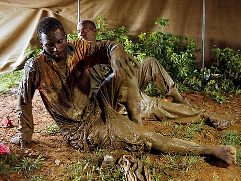 Artisanal miners Thankmore Mandimutsa and Simon Mushonga  sit in a tent after being rescued as retrieval efforts proceed for trapped illegal gold miners in Kadoma, Zimbabwe, February 16, 2019. 