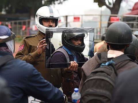 Sandeep Shahi (2L) holds up a mirror as part of a safety awareness campaign in New Delhi.