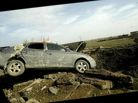 This picture shows a broken car during an operation of fighters of the US-backed Kurdish-Arab coalition of the Syrian Democratic Forces (SDF) to expel Islamic State group (IS) jihadists from their last bastion, in Baghouz in the eastern Syrian province of Deir Ezzor on February 16, 2019. Jihadist fighters defending the last dreg of the Islamic State group's "caliphate" on February 16 were holed up in half a square kilometre of a village in eastern Syria. President Donald Trump had announced that the fall of the IS proto-state would be declared on February 16, but a Syrian commander said his US-backed forces slowed down their advance to protect civilians. / AFP / Delil souleiman