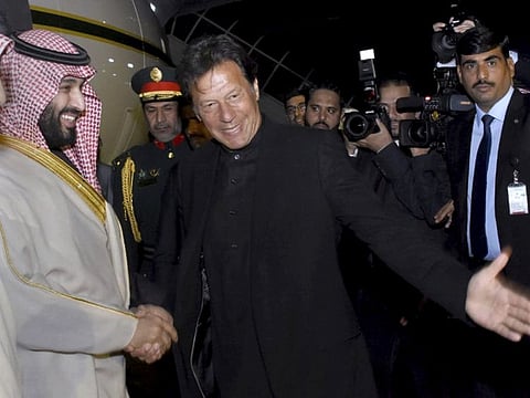 Pakistani Prime Minister Imran Khan greets to Saudi Arabia's Crown Prince Mohammad Bin Salman upon his arrival at Nur Khan airbase in Rawalpindi, on Sunday.