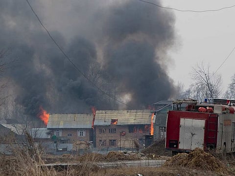 Flames and smoke billows from residential buildings where militants are suspected to have taken refuge during a gun battle in Pulwama, south of Srinagar, Indian controlled Kashmir, Monday, Feb. 18, 2019. 