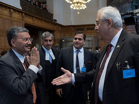 Pakistan’s attorney general Anwar Mansoor Khan, right, greets Deepak Mittal, the joint secretary of India’s Foreign Ministry, as he presented oral arguments at the International Court of Justice, or World Court, in The Hague, Netherlands, Monday, Feb. 18, 2019.