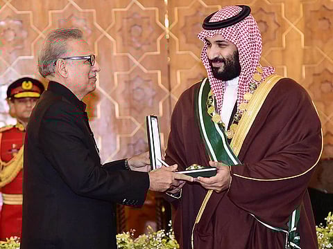In this handout photograph taken and released by Pakistan's Press Information Department (PID) on February 18, 2019, Pakistan's President Arif Alvi (L) confers the country's highest civilian award, the Nishan-e-Pakistan (Order of Pakistan), on Saudi Arabian Crown Prince Mohammed bin Salman at the President House in Islamabad.