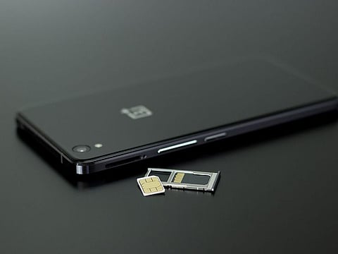 A smartphone with its sim card and memory card. For illustrative purposes only.