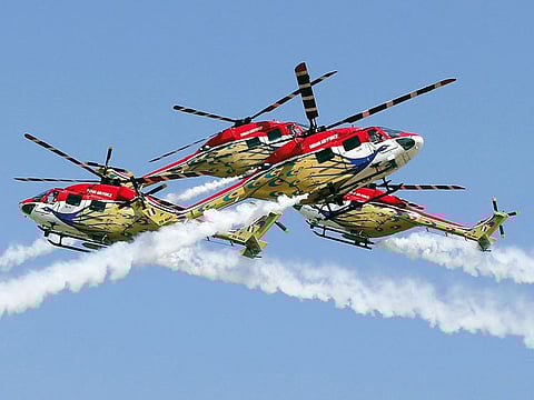 Indigenously manufactured Indian Air Force Dhruv helicopters perform aerobatic maneuvers on the inaugural day of Aero India 2019 at Yelahanka air base in Bengaluru.