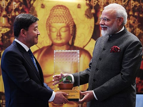 This handout photograph released by India's Ministry of External Affairs (MEA) on February 21, 2019, shows Indian Prime Minister Narendra Modi (R) giving a ficus religiosa tree sappling to Mayor of Gimhae Heo Seong Gon during his visit to South Korea's capital Seoul
