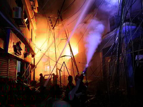 Firefighters work at the scene of a fire that broke out at a chemical warehouse in Dhaka, Bangladesh February 21, 2019.