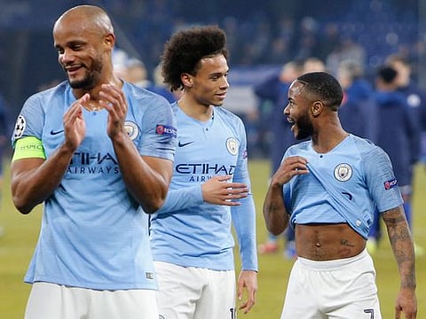 Manchester City midfielder Leroy Sane, center, who scored his side's second goal, and forward Raheem Sterling, right, who scored his side's third goal, celebrate their 3-2 win after the first leg, round of sixteen, Champions League soccer match between Schalke 04 and Manchester City at Veltins Arena in Gelsenkirchen, Germany, Wednesday Feb. 20, 2019.