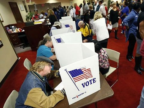 Last minute voters rush to cast their ballots on Election Day at the Christ United Methodist Church precinct in north Jackson, Miss., Tuesday, Nov. 8, 2016.