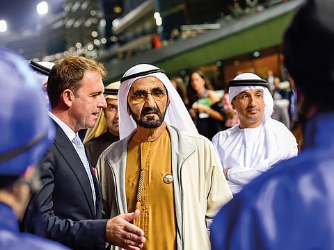 Shaikh Mohammad Bin Rashid Al Maktoum talking to trainer Charlie Appleby during the Dubai World Cup Carnival meeting at Meydan.