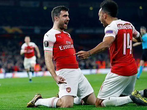 Arsenal's Sokratis Papastathopoulos celebrates scoring their third goal with Pierre-Emerick Aubameyang.
