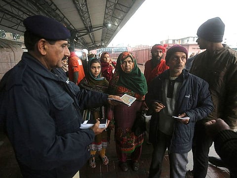 A Pakistani police officer checks documents of passengers travel to India via Samjhota Express at Lahore railway station in Pakistan, Thursday, Feb. 21, 2019.