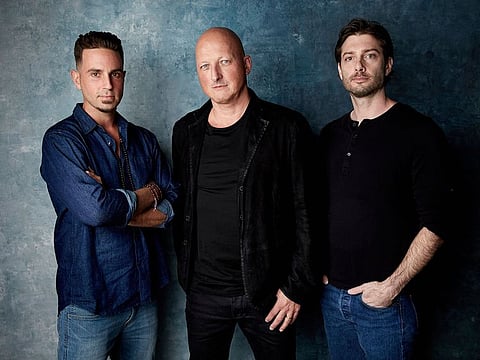 In this Jan. 24, 2019, file photo Wade Robson, from left, director Dan Reed and James Safechuck pose for a portrait to promote the film "Leaving Neverland" at the Salesforce Music Lodge during the Sundance Film Festival in Park City, Utah.