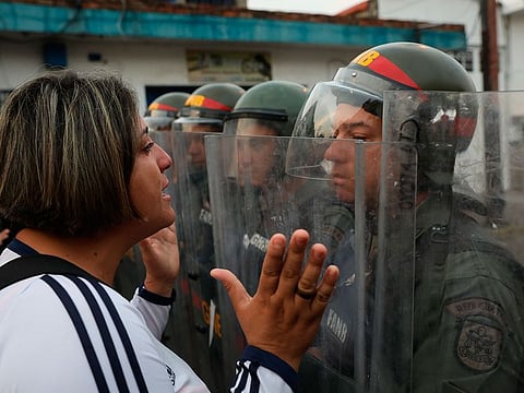 A demonstrator confronts a member of the Bolivarian National Guard in Urena, Venezuela, near the border with Colombia, Saturday, Feb. 23, 2019.