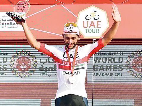 UAE Team Emirate’s Fernando Gaviria celebrates with the trophy.
