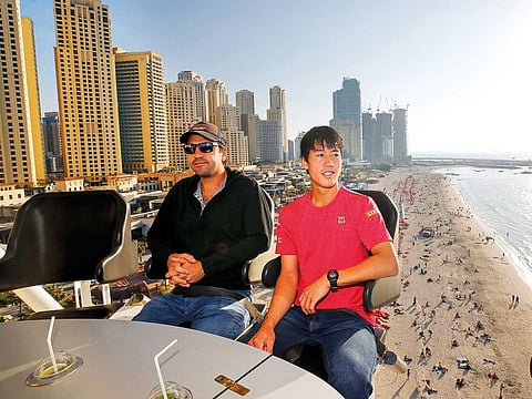 Kei Nishikori with his coach Dante Bottini on The Flying Cup, at JBR, Dubai.